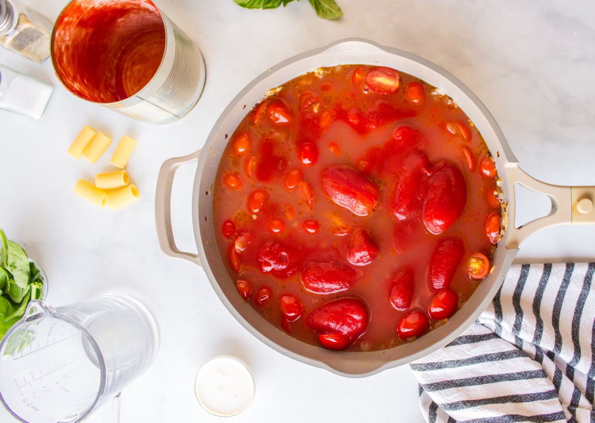 broth and canned tomatoes added to pan